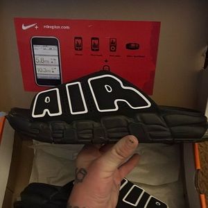 Nike uptempo slides. AIR on both sides of shoe. Black with white lettering.